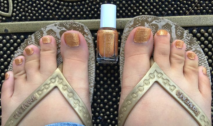 a bronze pedicure with copper shimmer polish on toes.
