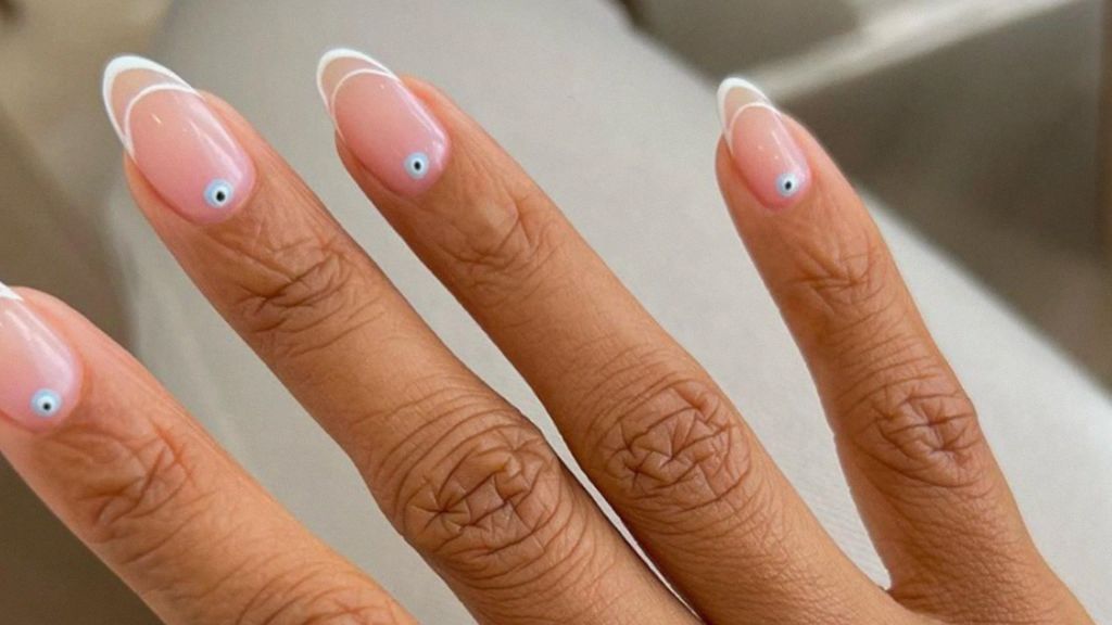 a woman showing off her newly done round shaped nails
