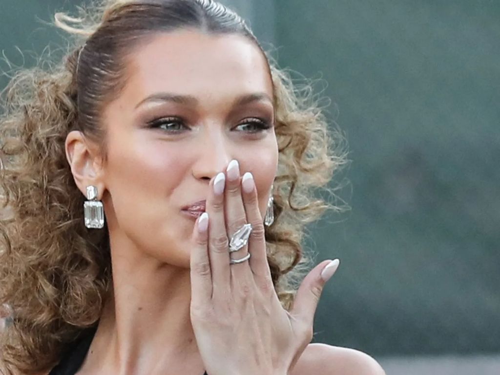 bella hadid is a master of using negative space in her nail designs to create a clean, minimalist look.