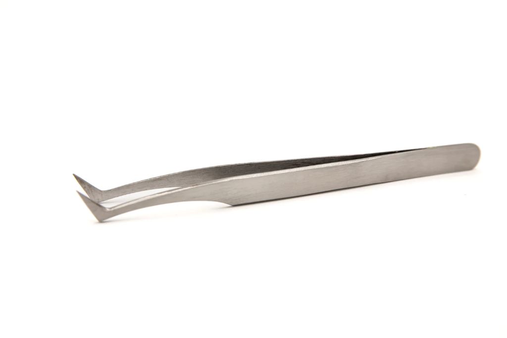 image of stainless steel tweezers being used for precision nail care