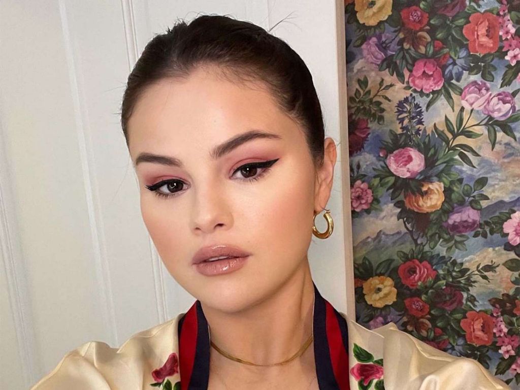 photo of selena gomez showing off her signature floral nail art
