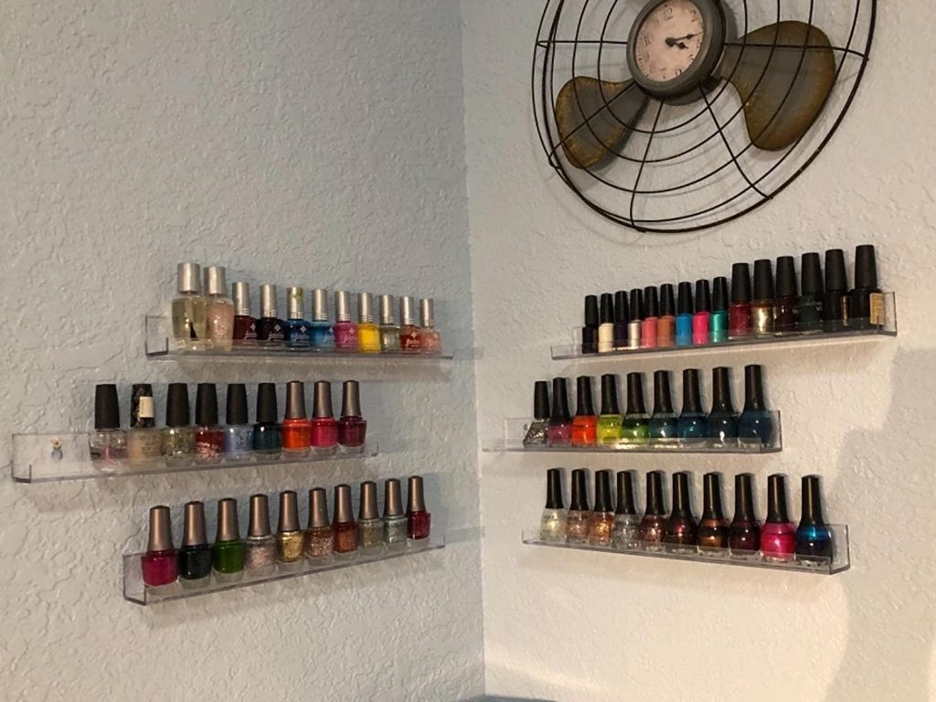 wall-mounted shelves provide easy access to organized nail polish bottles